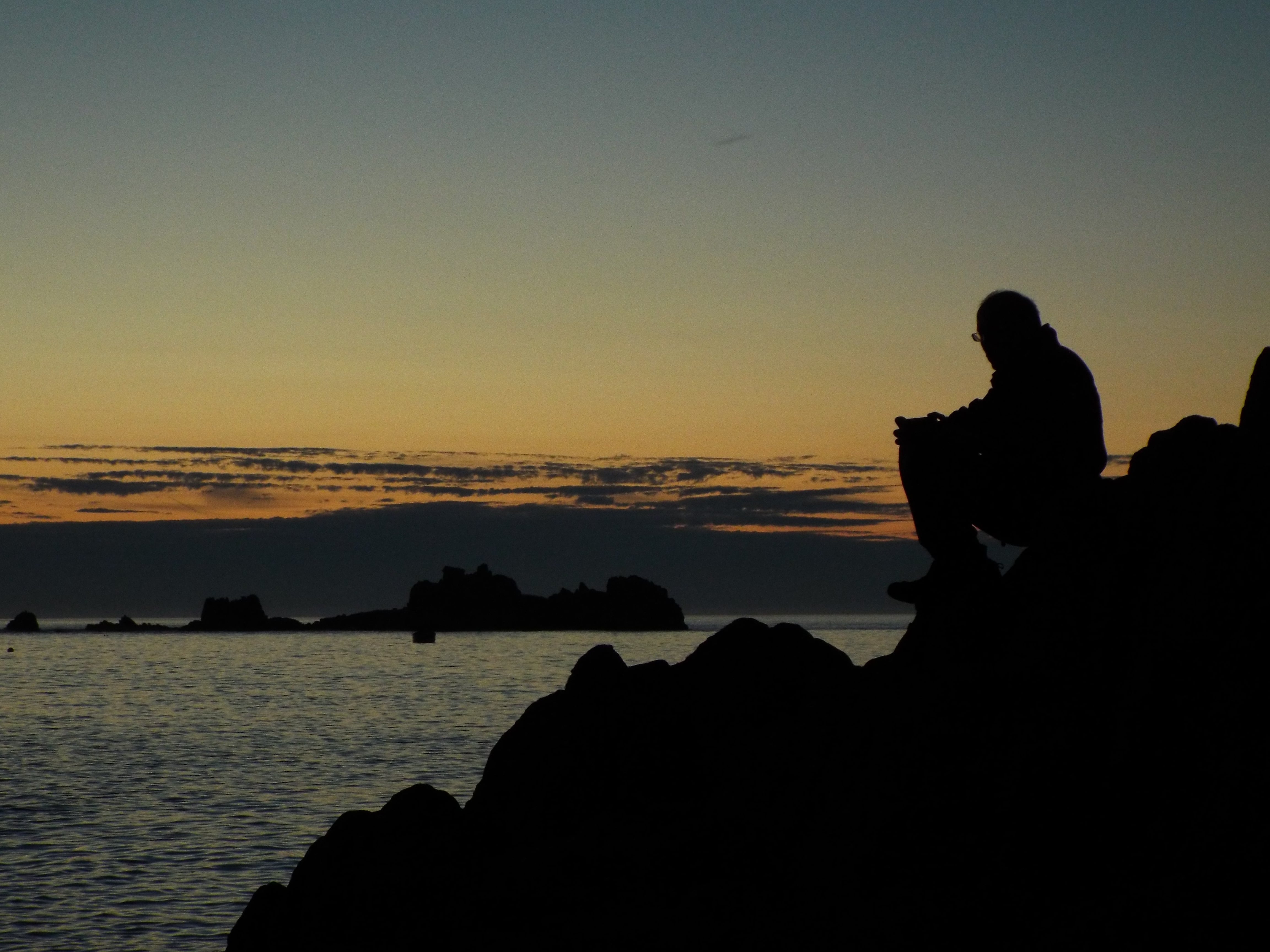 man sitting on rocks